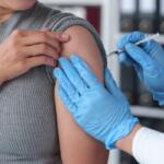 Hands of a male doctor or professional nurse in medical gloves injecting antiviral medicine to a patient. treatment concept medical services.