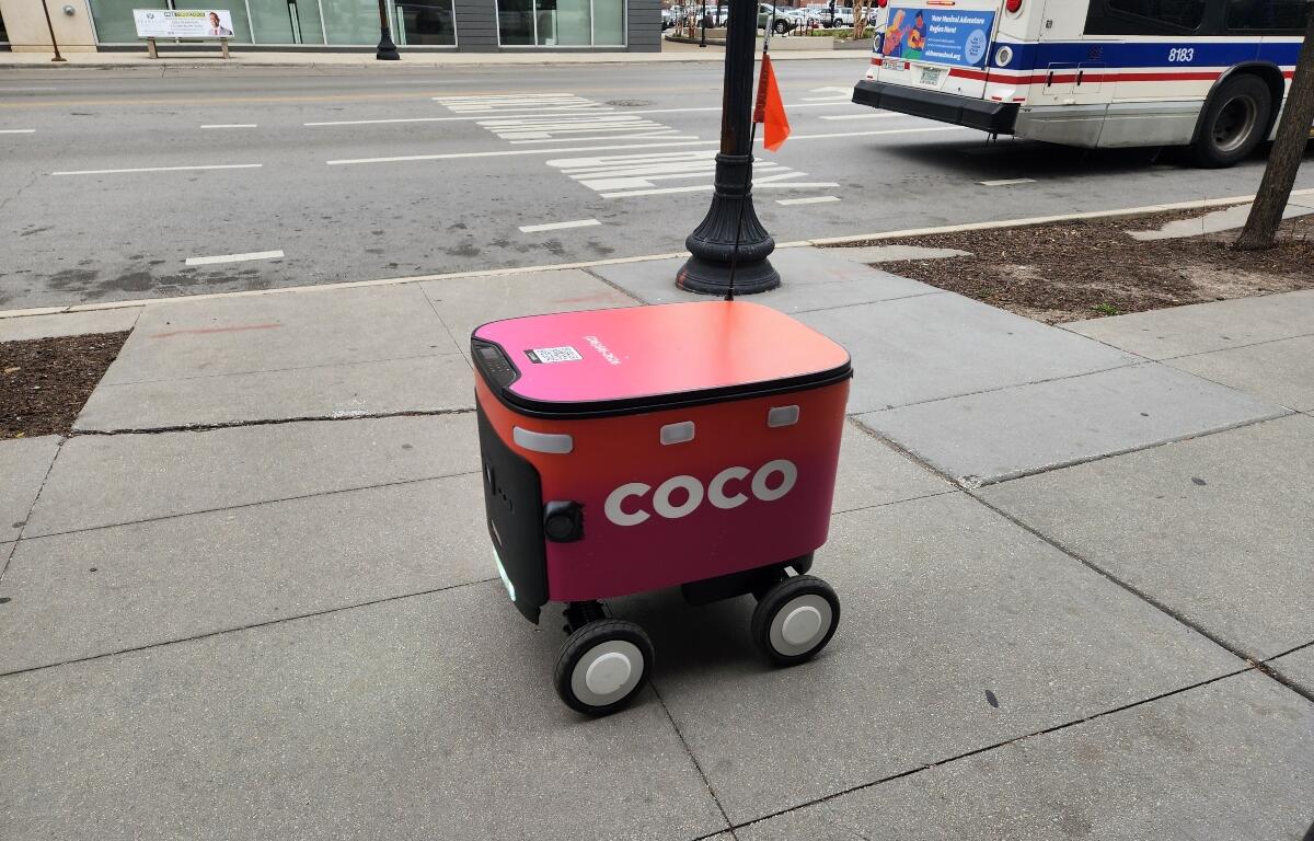 Chicago, IL April 17, 2025, Coco food delivery robot cart going down the sidewalk, automated