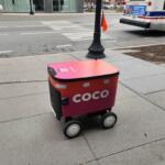Chicago, IL April 17, 2025, Coco food delivery robot cart going down the sidewalk, automated